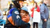 White officer -- one of the good guys -- hugs a black boy who is crying from fear that police officers might kill him because he's black. Officer Bret Barnum and Devonte Hart.