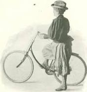 A woman wearing bloomers with her bike.