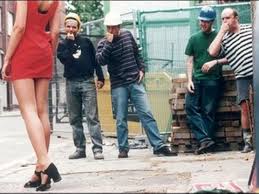 Men catcalling a woman